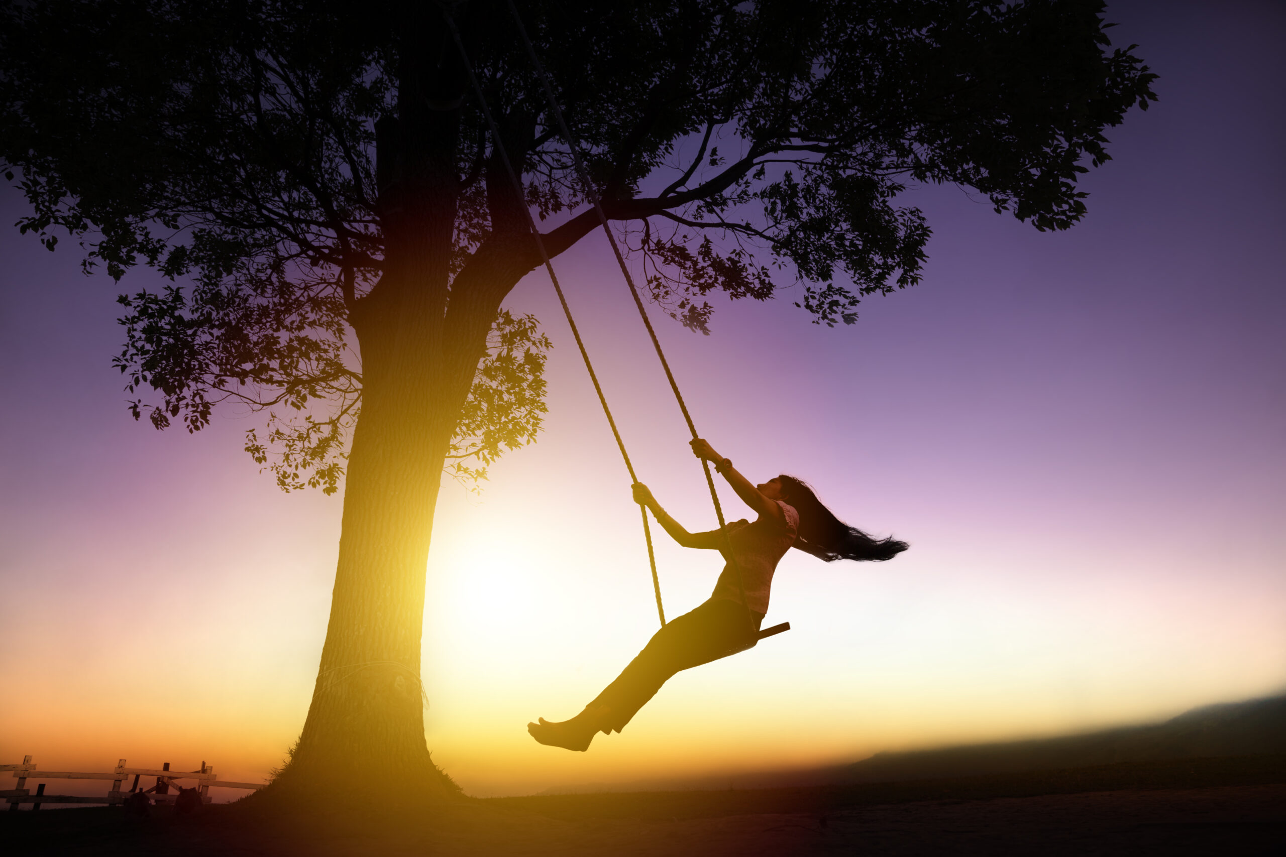 Silhouette of a happy young woman representing happiness and emotional wellbeing