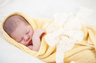 0bigstock-sleeping-newborn-baby-wrapped--35695436
